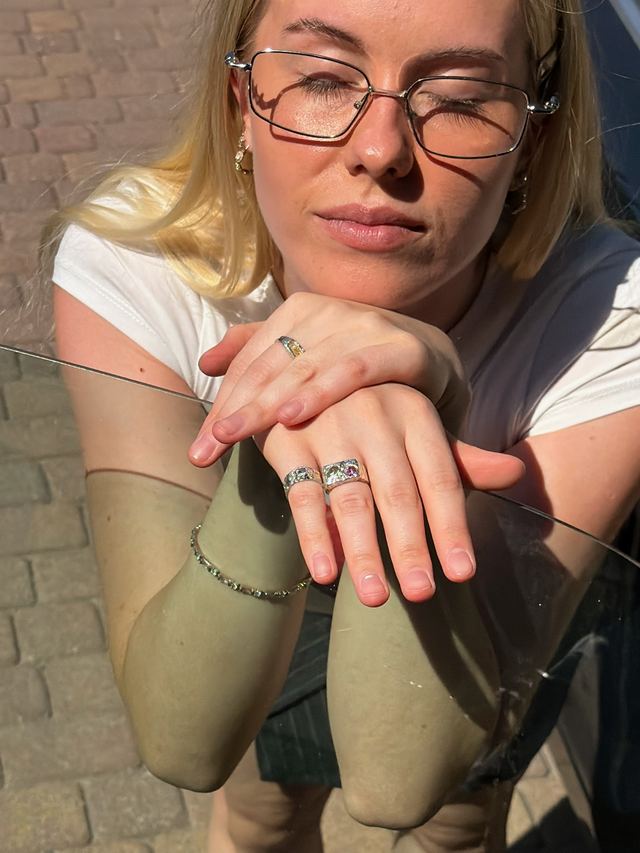 Hands wearing ARTarual rings while choosing a size