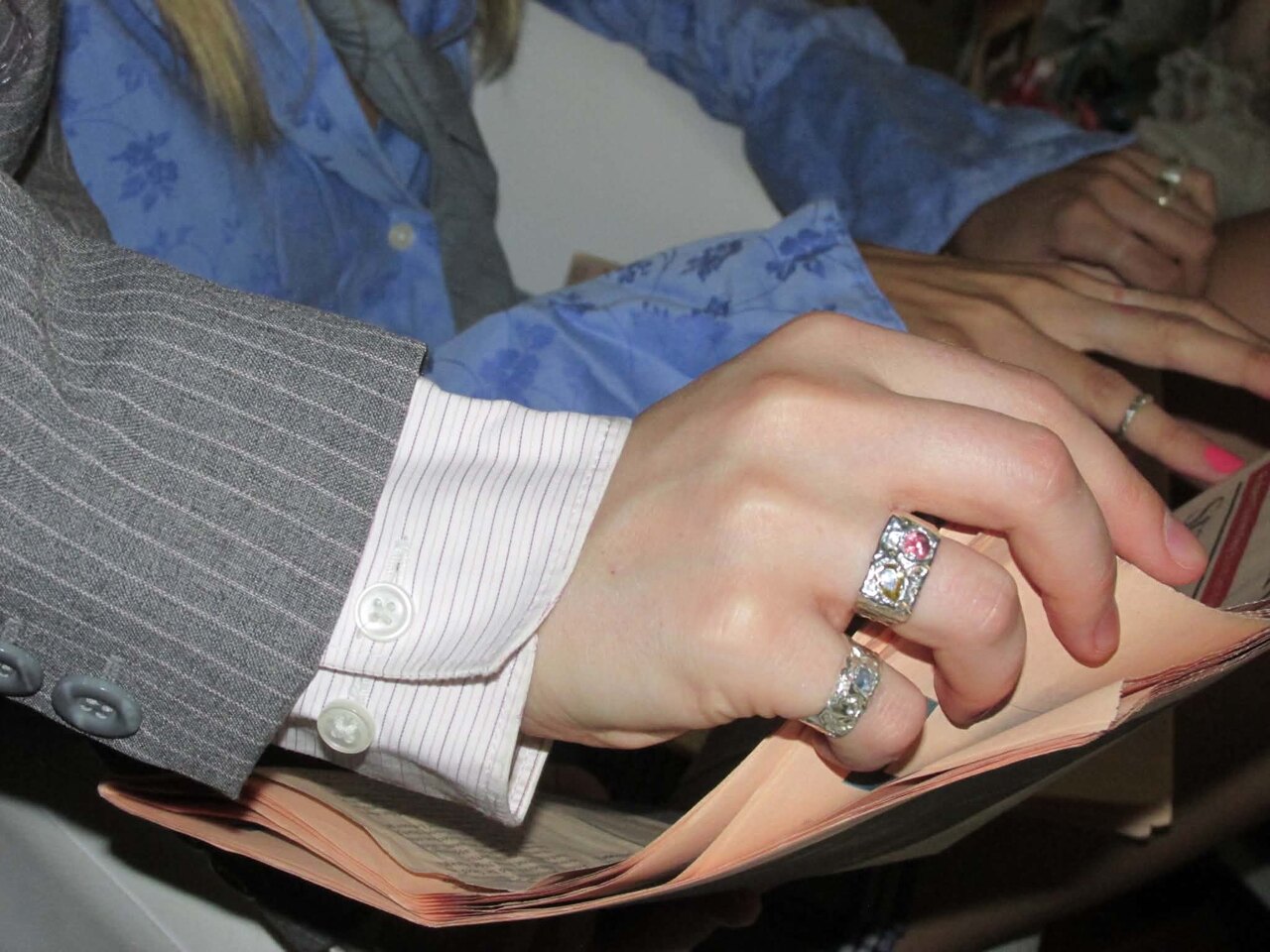 A close-up of two ARTarual rings, worn stacked